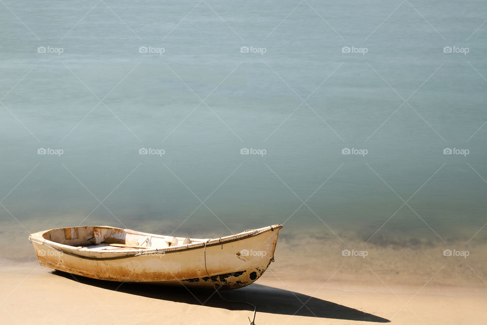 little rowing boat pulled up at the waters edge at Noosa, Queensland