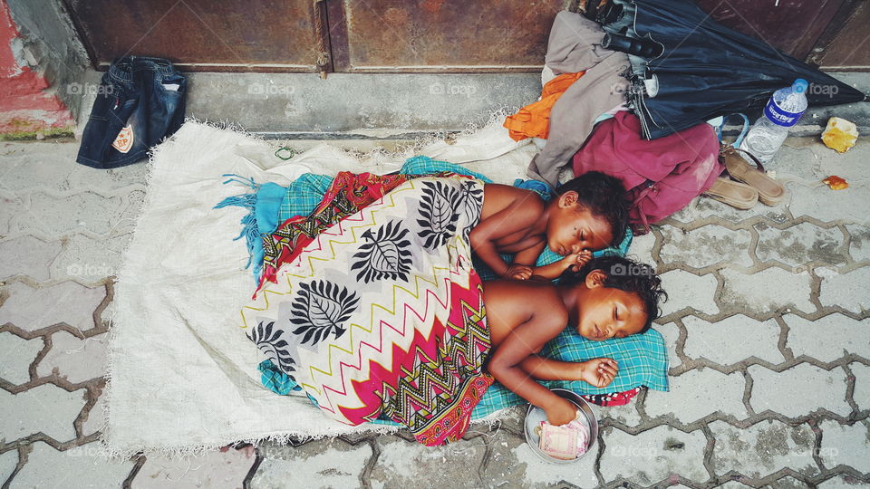 Beautiful poor kids of Nepal. picture was taken while waking on Kathmandu streets. little beggars fall asleep while asking for money.