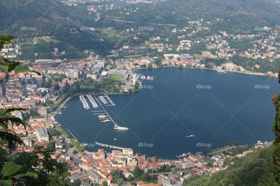 Lake Como surrounded with the city of Como seen from the high look out point 