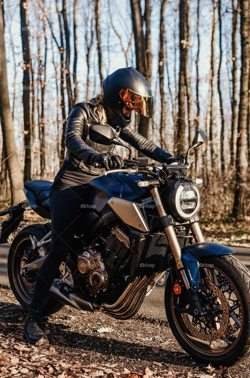 Female motorcycle rider on a blue motorcycle