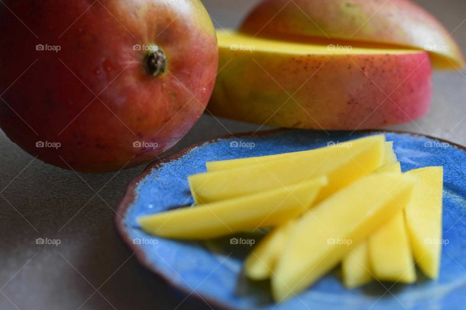 Close-up of mango with sliced on plate