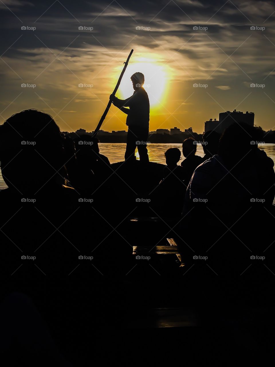 Silhouetted people on boat