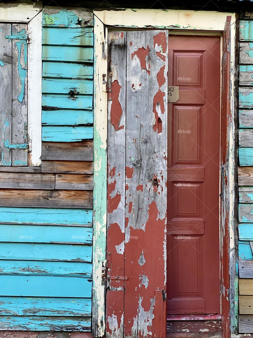Bright peeling paint on an old wood house
