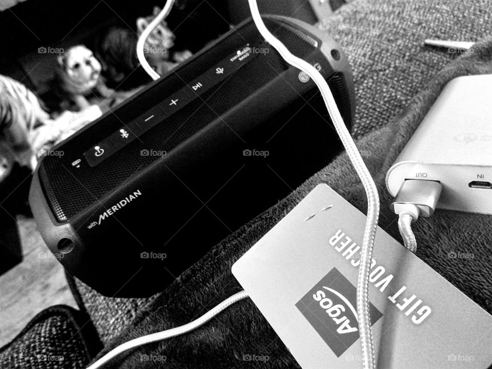 my wireless speaker, a Argos gift voucher and my battery charger charging my speaker