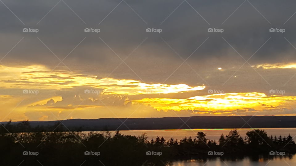 Sunset over the lake with hill in background