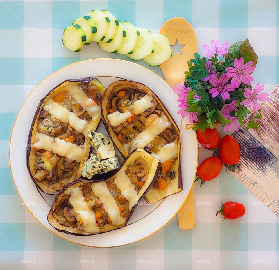 Stuffed eggplant with vegetables,  mushrooms, and cheese . Delicious vegetarian lunch