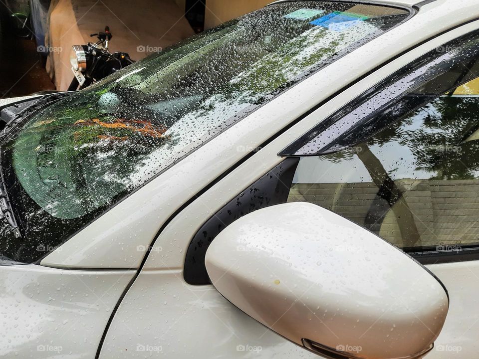 Raindrops on a white car