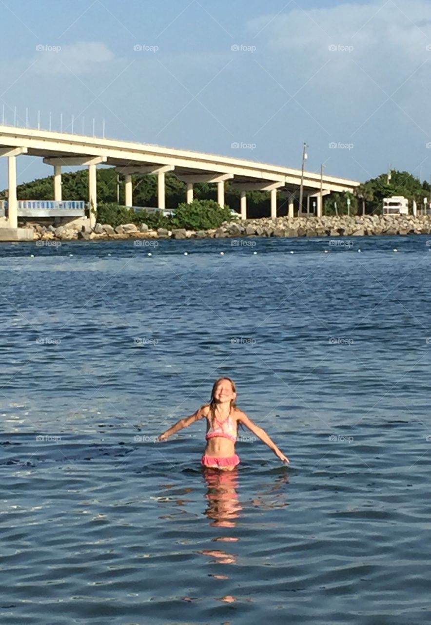 Little girl enjoying the ocean at the Sebastian inlet 