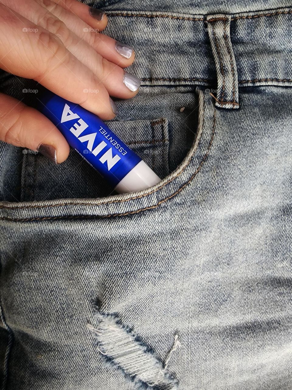 Grabbing my Nivea essentials lip balm from my pocket.