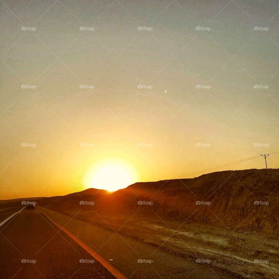 sun behind the hills