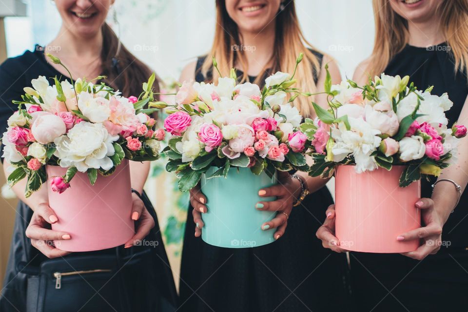 Girls holding flowers box