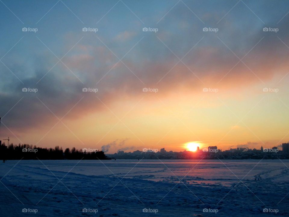 sunset in winter with cold weather in January, frost and sun