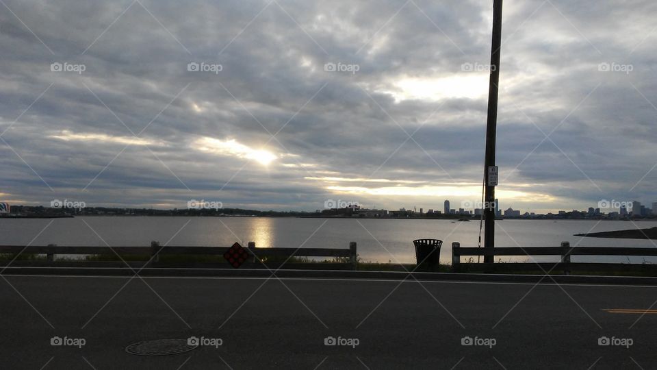 sky. water. calm
 sun. clouds