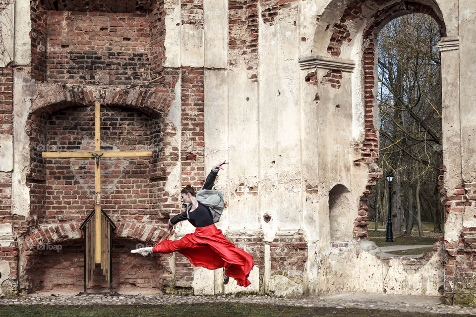 girl dancing in the park near the ruined church