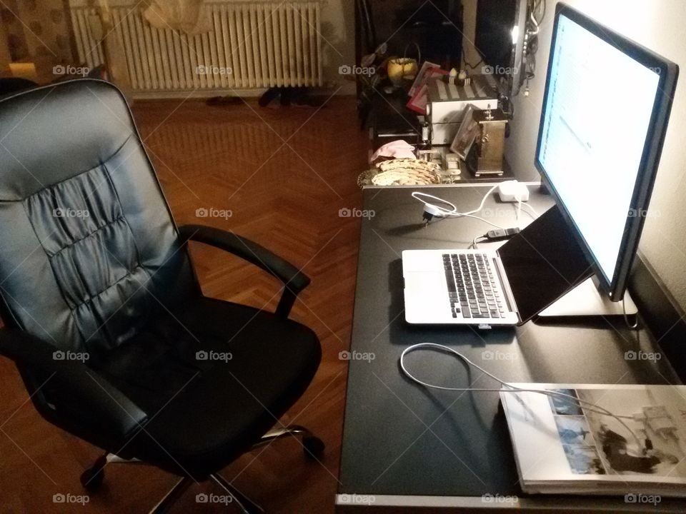 office desk with leather chair and notebook apple macbook pro