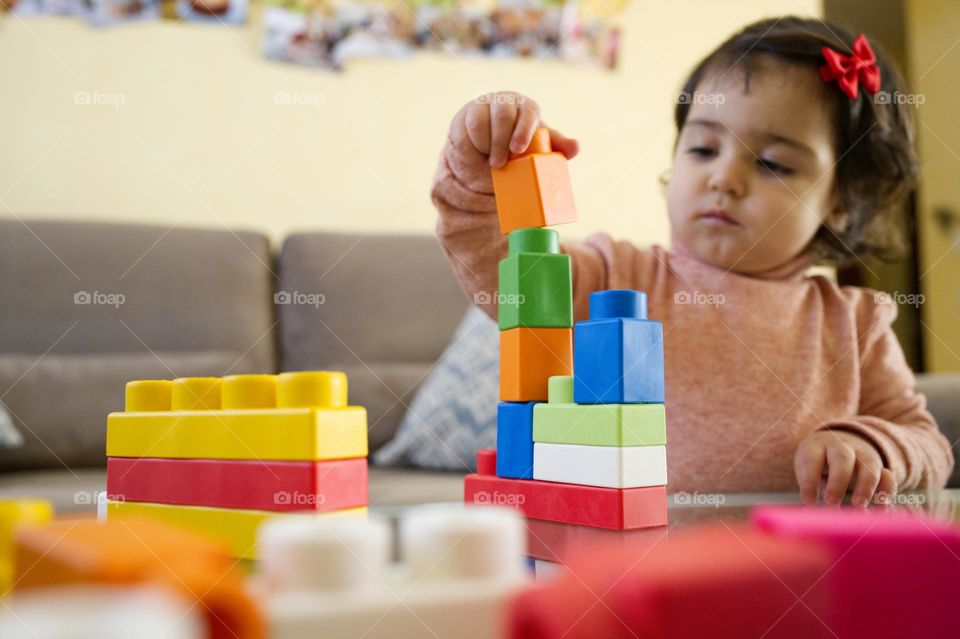 my little girl playing with building blocks