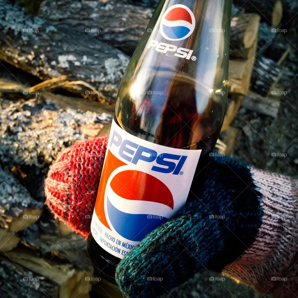 Pepsi with a Hand in a Mitten holding it