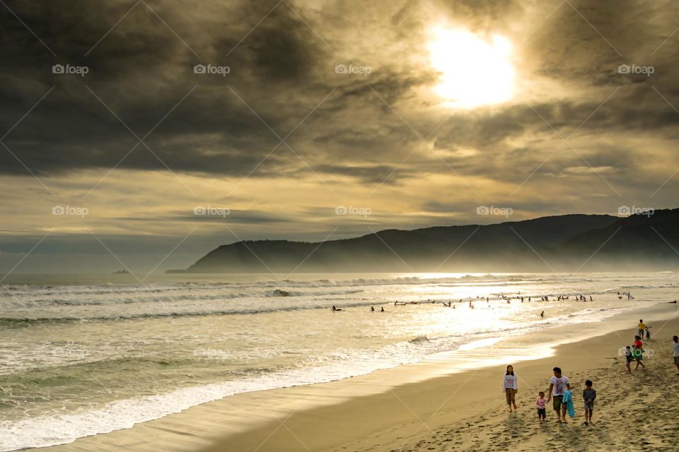 a beach with a cloudy sky