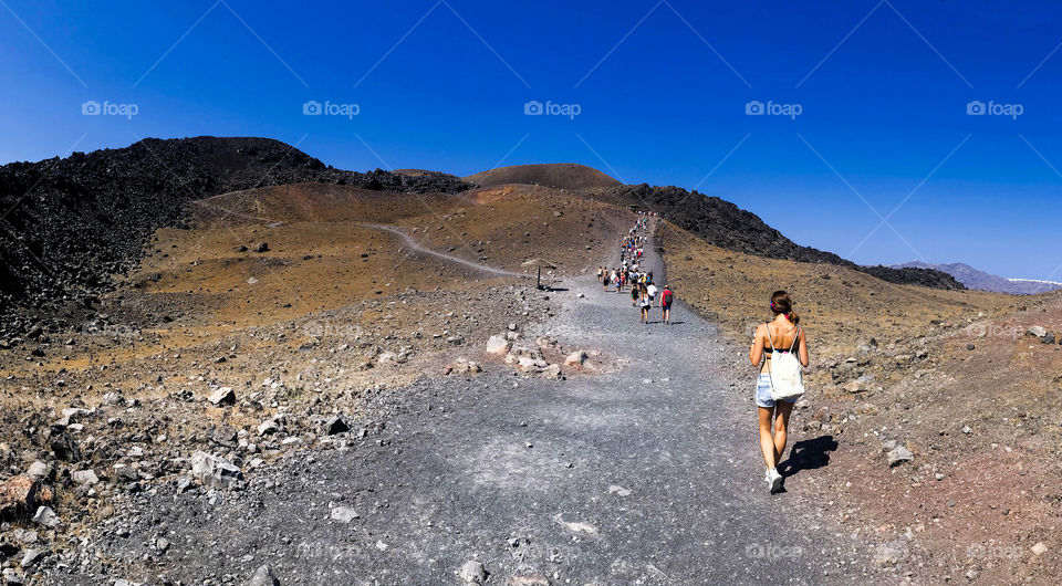 Group of people ascending the mount Vesuvius in Naples, Italy.