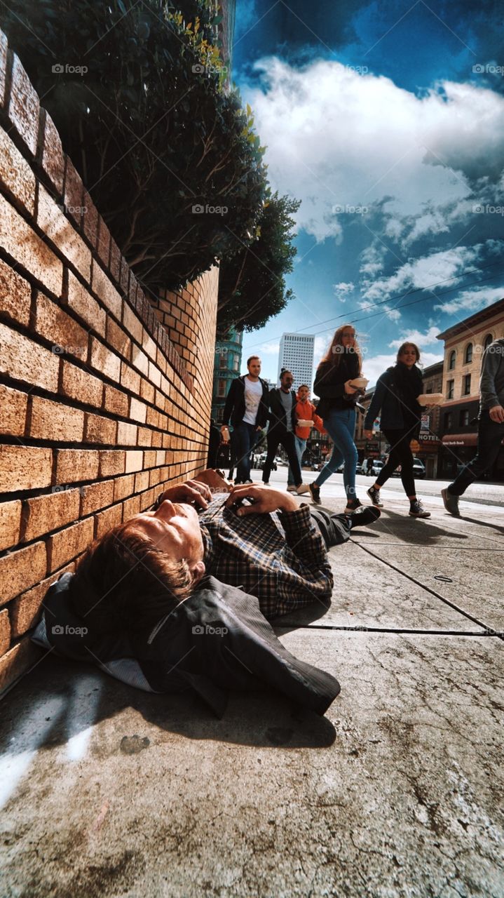 Ten minutes before I took this I was in the office watching the rain smash the streets like millions of little bullets shattering into the pavement.... apparently someone wanted to shine light on this young man. Because now he’s warm and dry. 