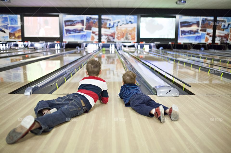 Kids bowling at a bowling alley 