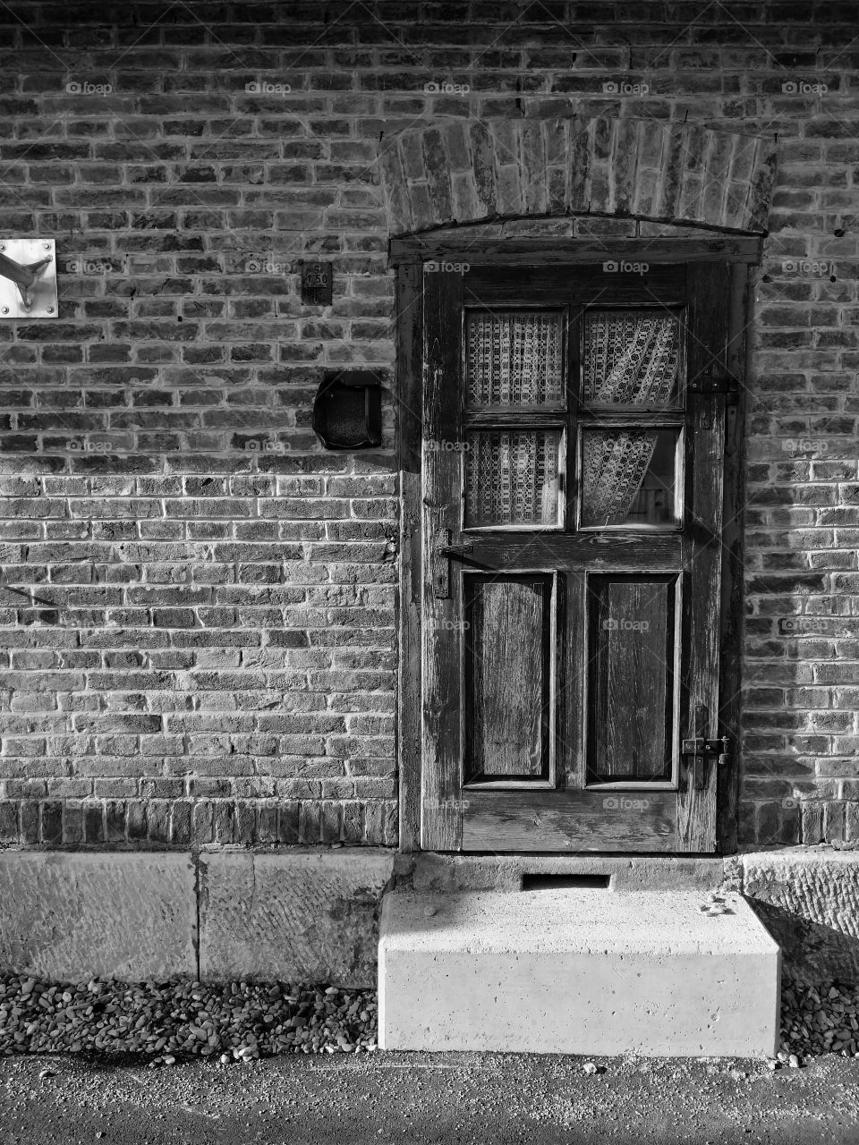 Old door with curtains in a brick building