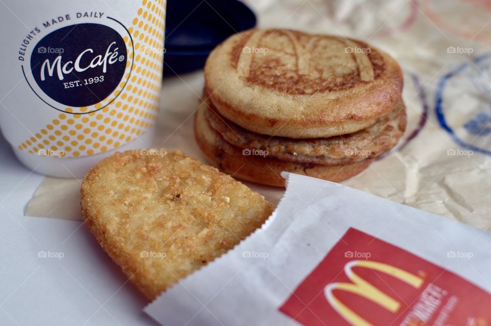 McDonald’s Mc Café sausage McGriddle hash brown close up side flat lay