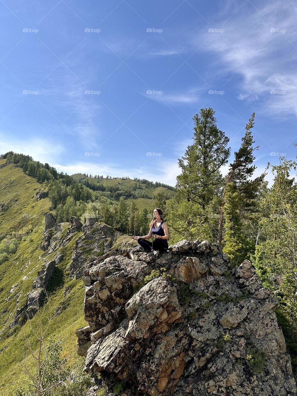 girl meditating on a rock