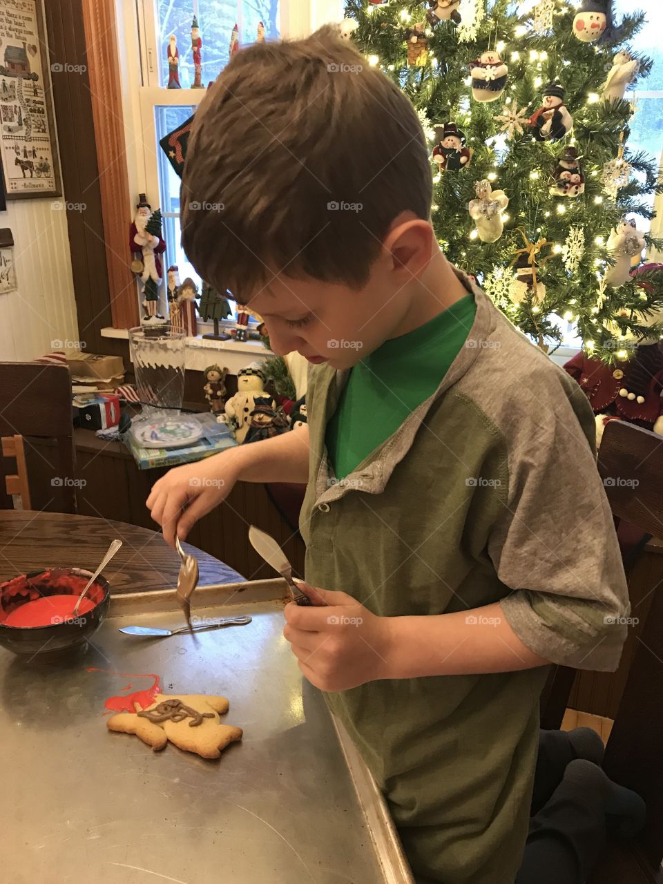 Decorating yummy Christmas cookies with mason 