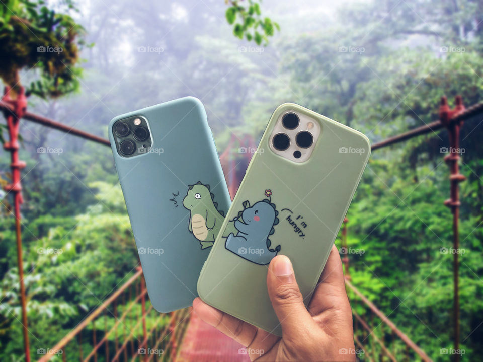 Couple iPhones cases in forest