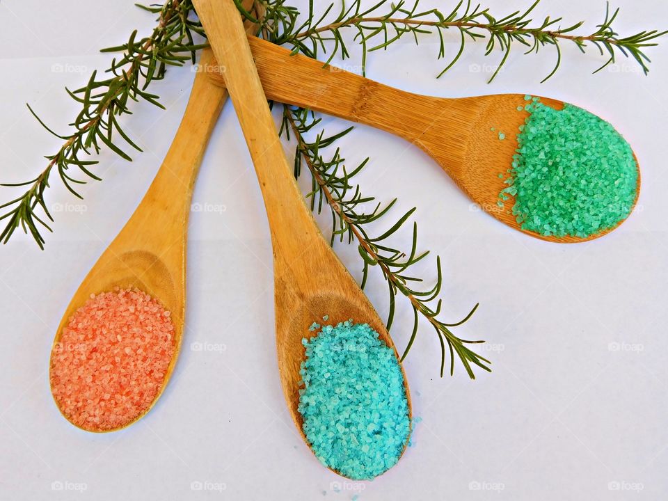 Flat lay photo - Bird’s eye view of three wooden spoons filled with different colored salt