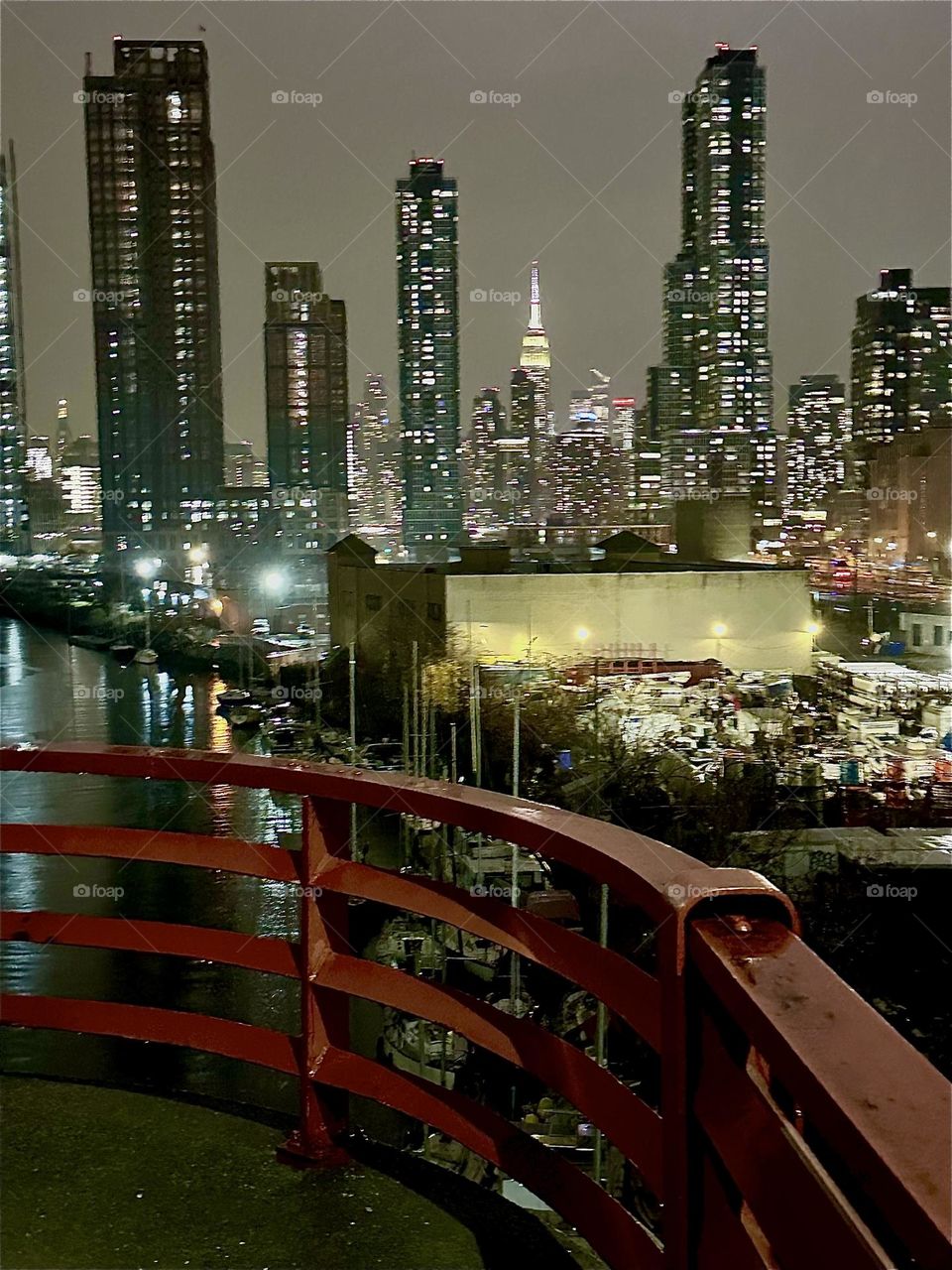 This is „Newtown Creek“ seen from the „Pulaski Bridge“ in LIC, Queens at night. „Manhattan“ and the illuminated „Kreisler Building“ are visible from here especially when the sky is clear. 2023. Hypnotic Productions