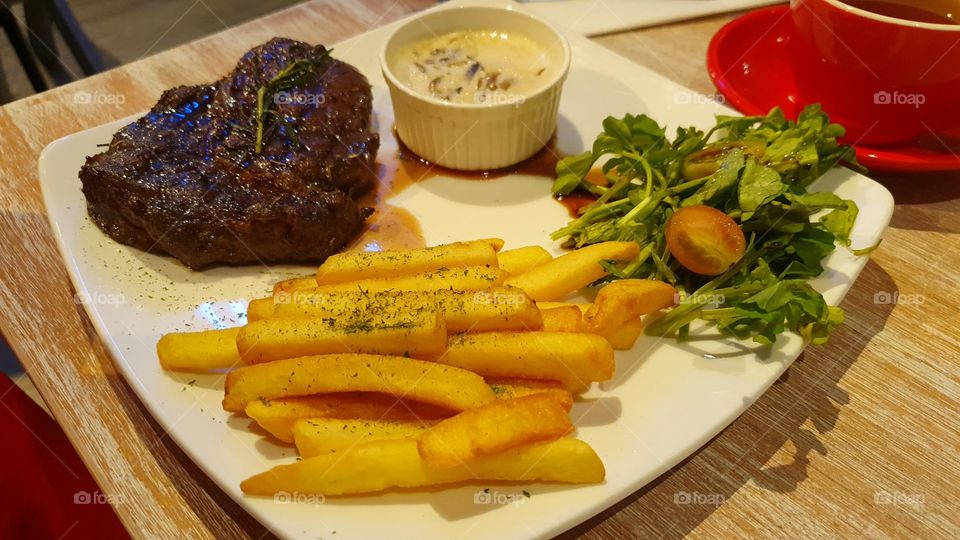 Ribeye steak with fries