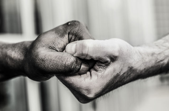 Close-up of two man holding hands