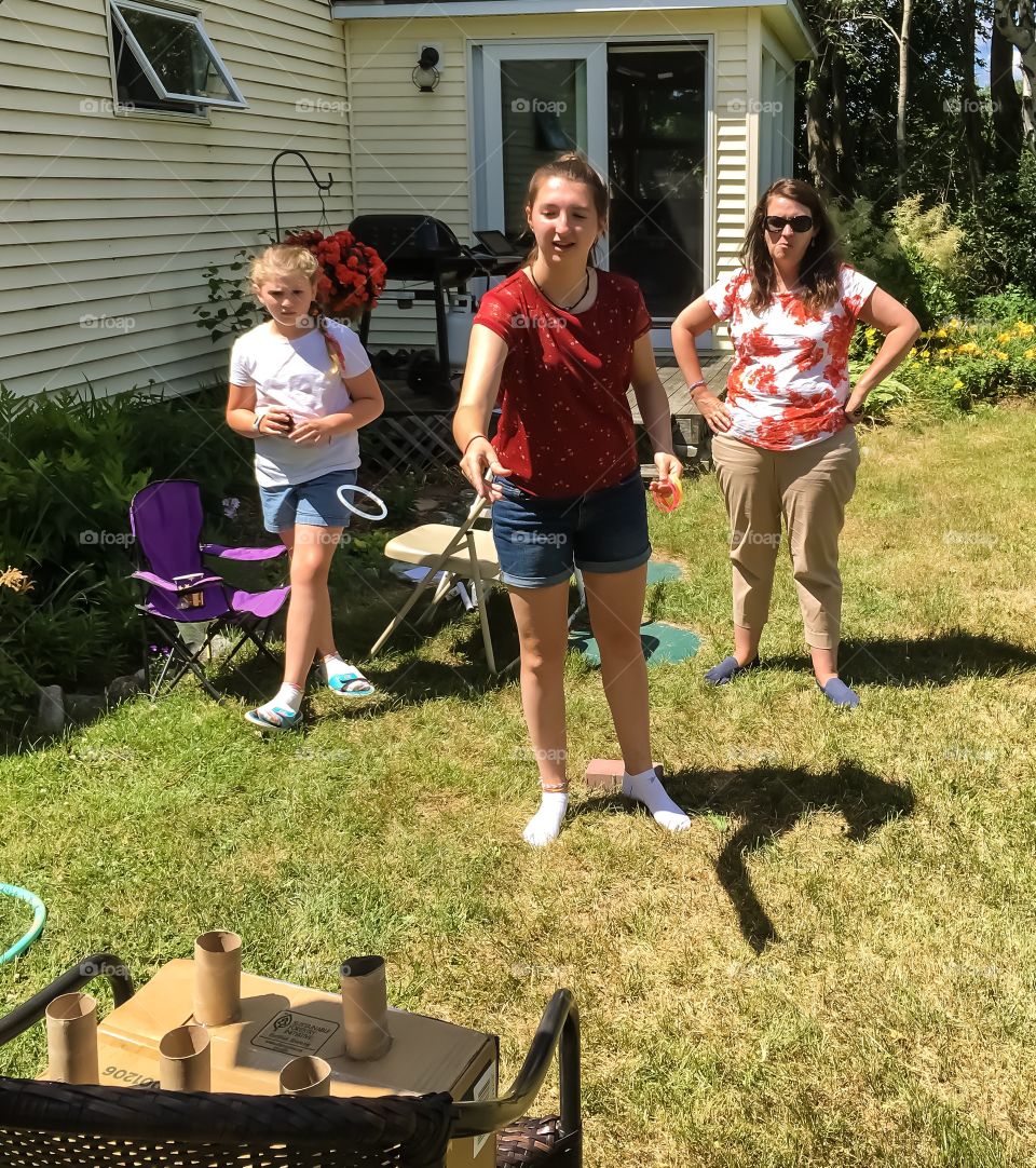 Playing a homemade ring toss game in the backyard with family.  It was pretty hard to be successful! 