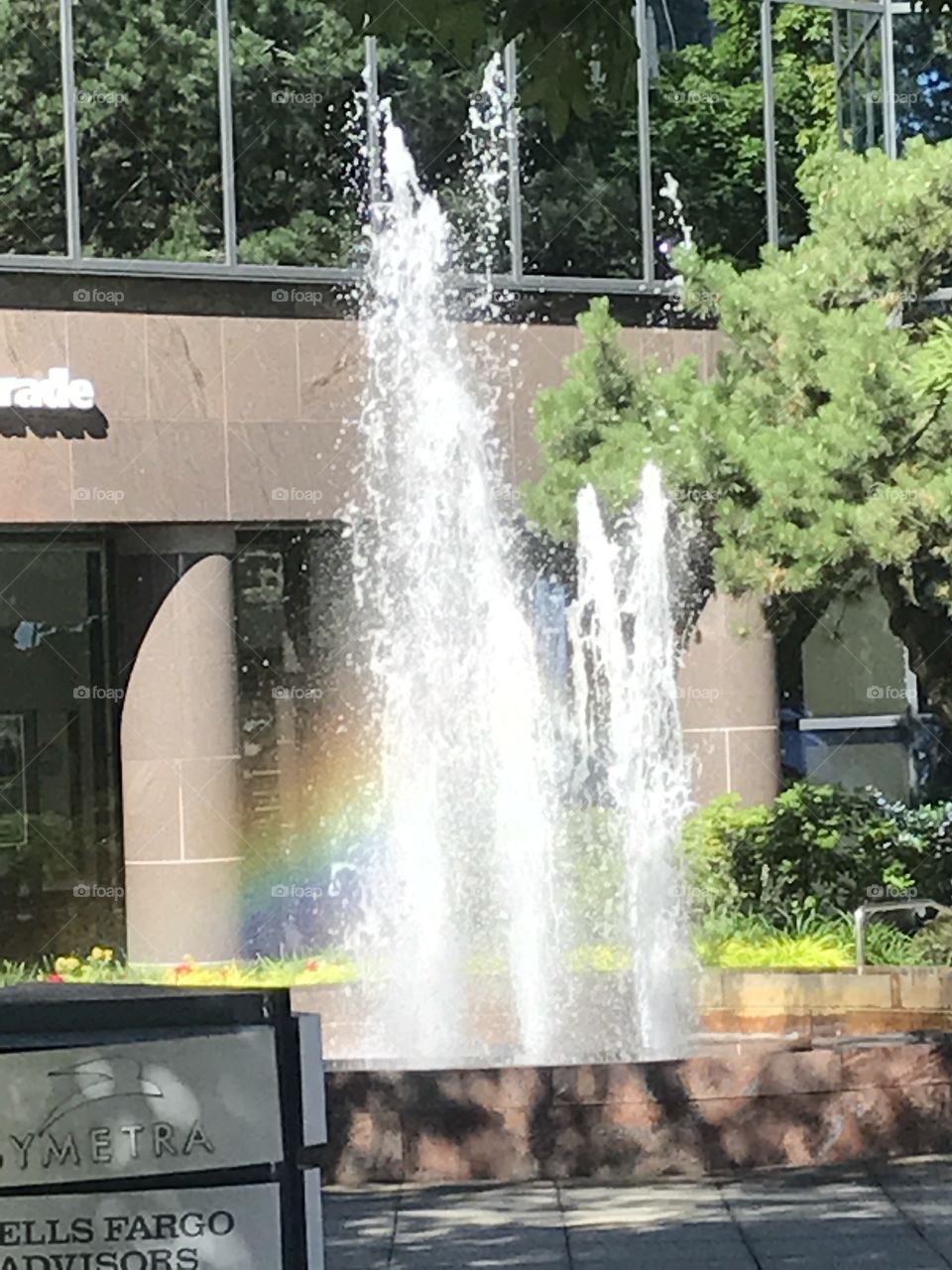 A fountain in Bellevue with the rainbow