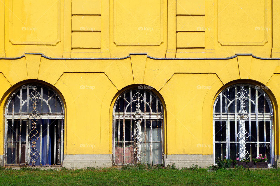 Windows and yellow coloured facade of Széchenyi Thermal Bath in Budapest, Hungary.