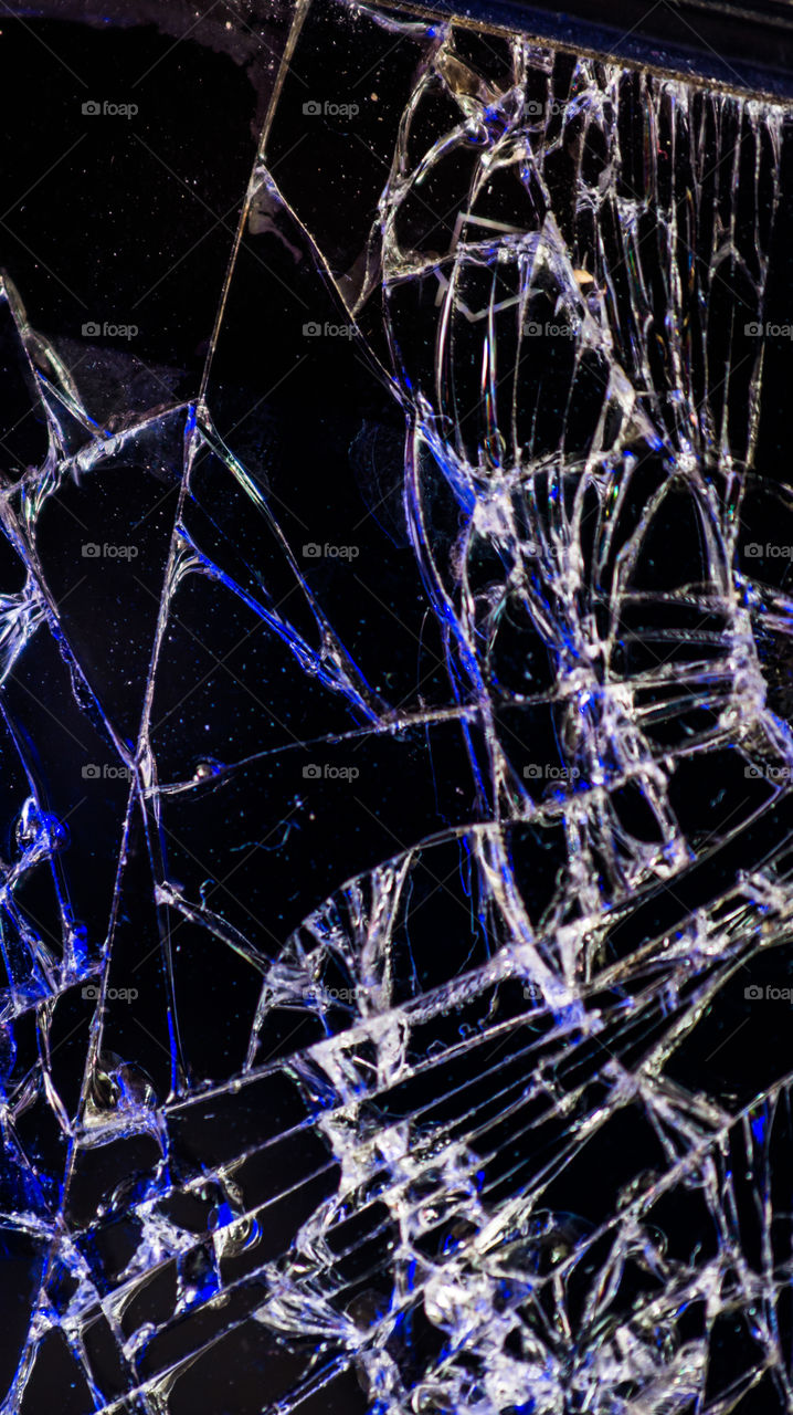 Multi-colored and bright broken smartphone screen close-up.