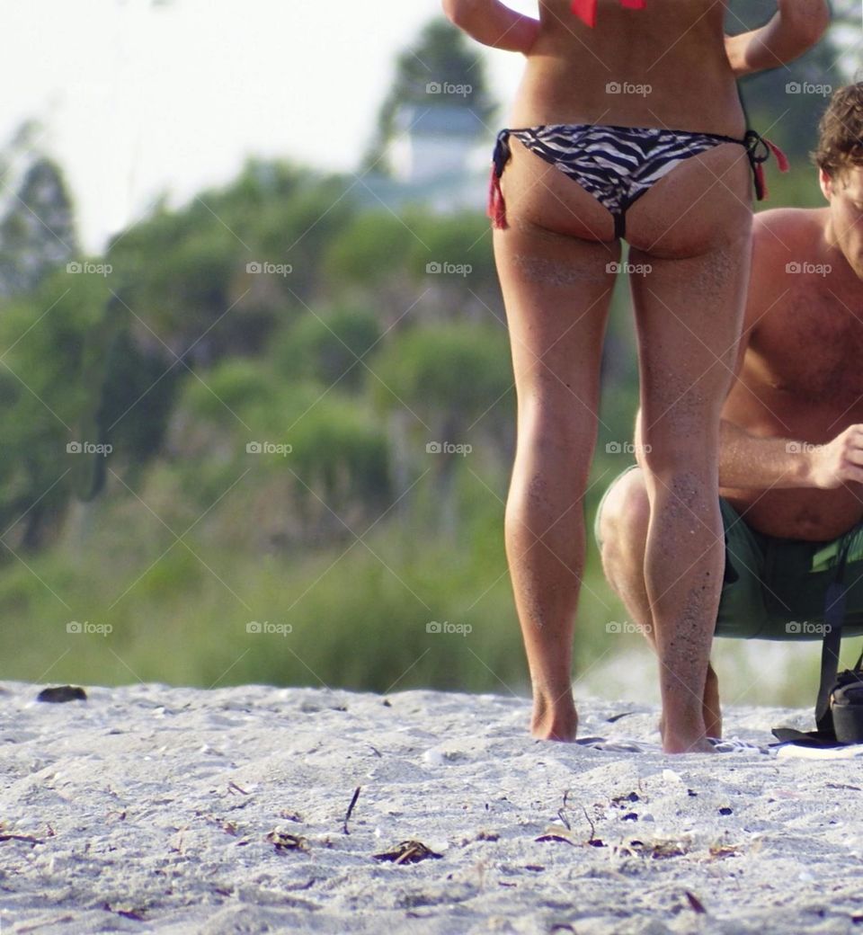 Woman rocking  a t- back bikini.