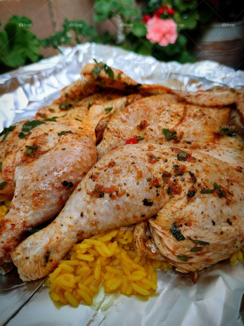 rice with saffron on top of which two chicken carcasses, which are grated with spices