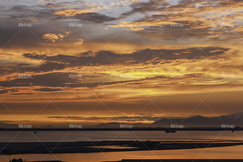 Golden colors lights up the skies of Penang Island right before the sun comes up.