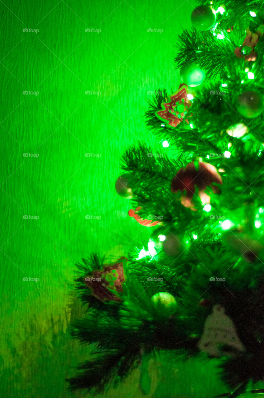 Green light of Christmas tree and space for text 