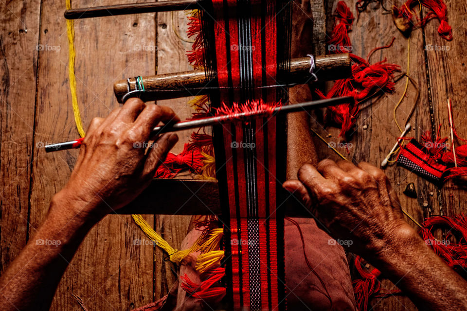 A person working at loom