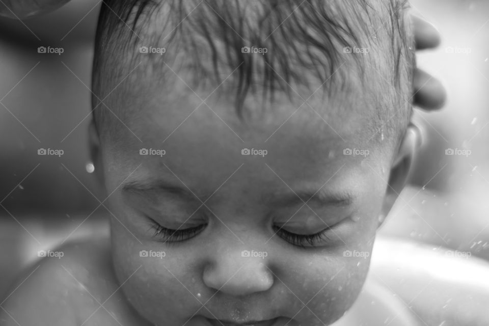 Cute face of a baby in the bath