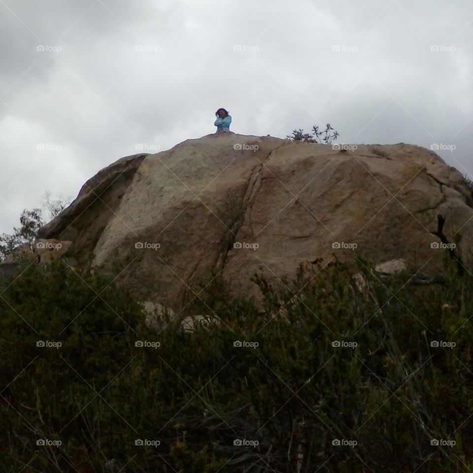 standing on top of giant rock