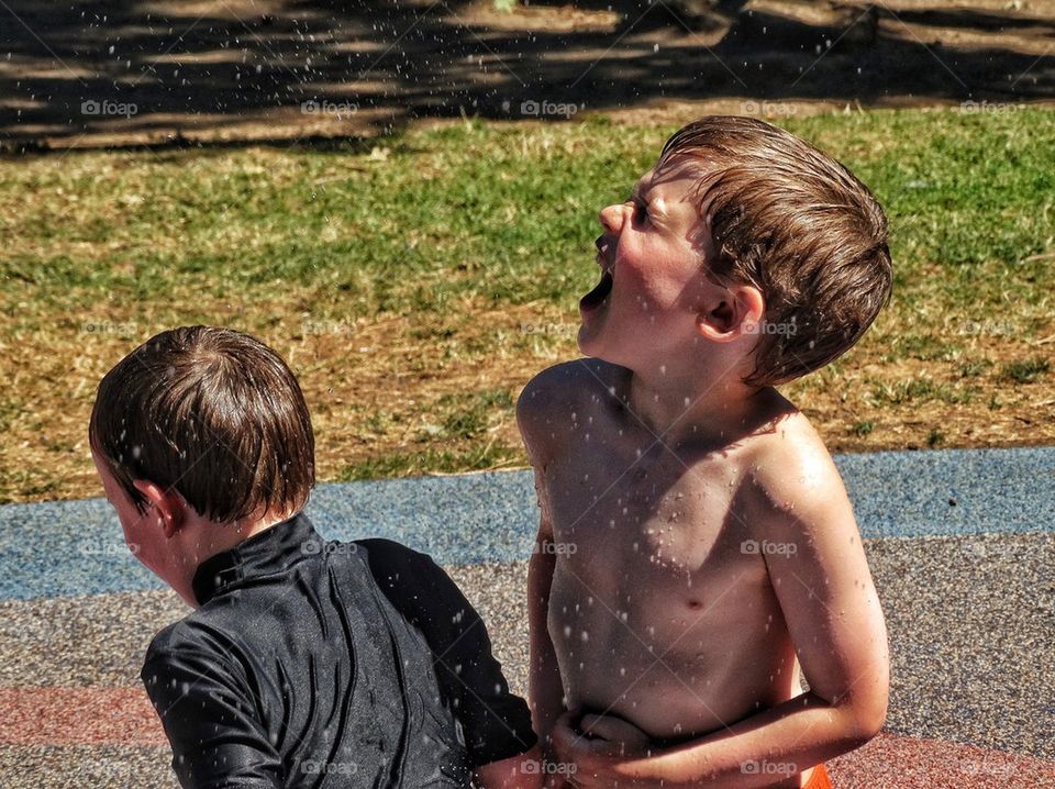 Brothers Playing In Water Fountain