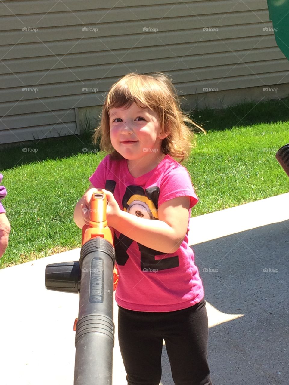 Papa' s little helper. Granddaughter helping her papa with yard work