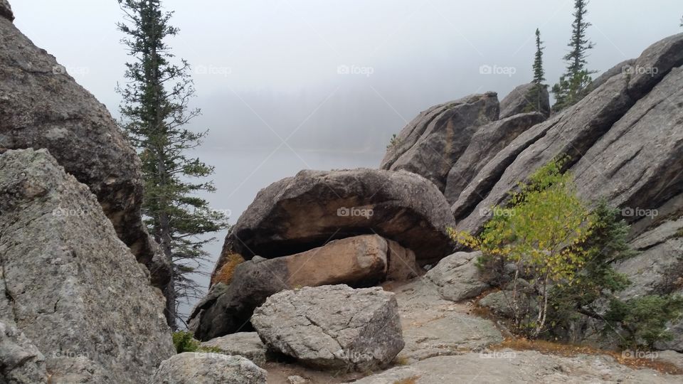Rocky boulders on a ledge overlooking a lake