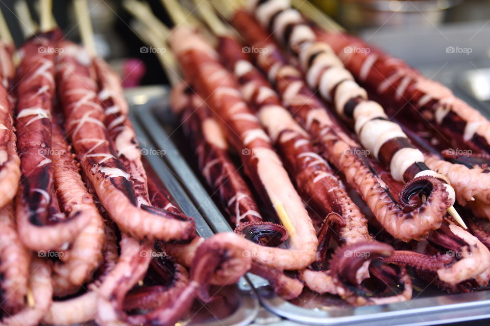 Asia China Beijing street food market at Wang Fu Jing. Big tentacle for eat Octopus to go