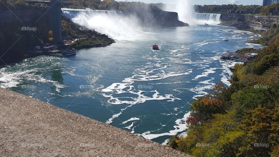 boats floating down rapid River from Niagara Falls Canada